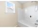 Clean bathroom features a tub and shower combination with a window providing natural light at 1104 Arden Trace Ct, Fuquay Varina, NC 27526