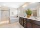 Bathroom featuring a walk-in shower, a tub, and double sinks with dark cabinets at 1104 Arden Trace Ct, Fuquay Varina, NC 27526