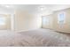 Spacious bedroom showcasing neutral walls, plush carpeting, and abundant natural light at 1104 Arden Trace Ct, Fuquay Varina, NC 27526