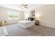 Bright bedroom with a ceiling fan, gray carpet, and a window with natural light at 1104 Arden Trace Ct, Fuquay Varina, NC 27526