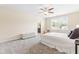 Well-lit bedroom with neutral walls, carpet, and a window allowing natural light at 1104 Arden Trace Ct, Fuquay Varina, NC 27526