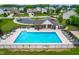 Aerial view of community pool with abundant seating, surrounded by homes at 1104 Arden Trace Ct, Fuquay Varina, NC 27526