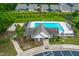 Aerial view of community pool with lounge chairs and picnic tables at 1104 Arden Trace Ct, Fuquay Varina, NC 27526
