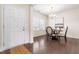 The dining room has hardwood floors, a window, and a chandelier hanging over a round table set for two at 1104 Arden Trace Ct, Fuquay Varina, NC 27526