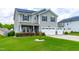 Two-story home with gray siding, black shutters, solar panels, well-manicured lawn, and a two car garage at 1104 Arden Trace Ct, Fuquay Varina, NC 27526