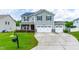 Two-story home with gray siding, black shutters, solar panels, well-manicured lawn, and a two car garage at 1104 Arden Trace Ct, Fuquay Varina, NC 27526