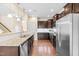 Bright kitchen with stainless appliances, granite counters, and views to the staircase at 1104 Arden Trace Ct, Fuquay Varina, NC 27526