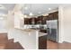 Stylish kitchen features granite counters, dark wood cabinets, and stainless steel appliances at 1104 Arden Trace Ct, Fuquay Varina, NC 27526