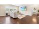 The living room has hardwood floors, a sofa, a rug, and a large window overlooking the front yard at 1104 Arden Trace Ct, Fuquay Varina, NC 27526