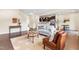 Spacious living room with hardwood floors, comfortable seating, and seamless transition to the adjacent kitchen at 1104 Arden Trace Ct, Fuquay Varina, NC 27526