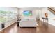 The living room features hardwood floors, a sofa, a side table, a rug, and a large window for natural light at 1104 Arden Trace Ct, Fuquay Varina, NC 27526