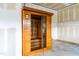 Interior of wooden sauna with glass door, adjacent to unfinished garage at 1104 Arden Trace Ct, Fuquay Varina, NC 27526