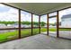Relaxing screened-in porch area with concrete flooring and views of the fenced backyard at 1104 Arden Trace Ct, Fuquay Varina, NC 27526