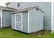 Outdoor storage shed with gray siding and a white door at 1104 Arden Trace Ct, Fuquay Varina, NC 27526