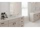 Bright and clean bathroom featuring double vanity, a glass-enclosed shower, and modern fixtures, all in white at 1105 Masters Place Way # 154, Durham, NC 27703