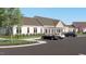 Community clubhouse with white siding, ample parking, well-manicured lawns, and a welcoming entrance at 1105 Masters Place Way # 154, Durham, NC 27703