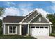 Charming gray home featuring a two-car garage, inviting front porch, and professionally landscaped front yard at 1105 Masters Place Way # 154, Durham, NC 27703