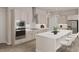 Bright kitchen with white cabinets, stainless steel appliances, modern lighting, and a kitchen island with seating at 1105 Masters Place Way # 154, Durham, NC 27703