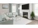 Cozy living room featuring a fireplace, large windows, plush seating, and modern decor with cool color accents at 1105 Masters Place Way # 154, Durham, NC 27703