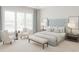 Serene main bedroom with a tufted headboard, bench, sitting area, large window, and modern decor at 1105 Masters Place Way # 154, Durham, NC 27703