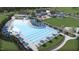 Aerial view of a large community pool with ample seating, shaded areas, and well-maintained landscaping at 1105 Masters Place Way # 154, Durham, NC 27703
