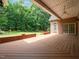Spacious covered back porch featuring wood decking and an outdoor ceiling fan at 11221 Paddy Hollow Ln, Raleigh, NC 27614