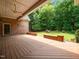 Spacious covered back porch featuring wood decking and overlooking the backyard at 11221 Paddy Hollow Ln, Raleigh, NC 27614