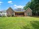 A wide angle view of the backyard and home featuring a large lawn and back porch at 11221 Paddy Hollow Ln, Raleigh, NC 27614