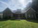Large backyard with mature trees and a spacious porch, perfect for outdoor entertaining and relaxation at 11221 Paddy Hollow Ln, Raleigh, NC 27614