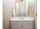 Elegant powder room featuring marble countertop, decorative wallpaper, and gold fixtures at 11221 Paddy Hollow Ln, Raleigh, NC 27614