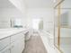 Well-lit bathroom featuring double sinks, vanity, and a shower and bathtub combination at 11221 Paddy Hollow Ln, Raleigh, NC 27614