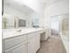 Well-lit bathroom featuring double sinks, vanity, and a large mirror at 11221 Paddy Hollow Ln, Raleigh, NC 27614