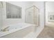 Well-lit bathroom featuring a jacuzzi tub and standalone shower at 11221 Paddy Hollow Ln, Raleigh, NC 27614