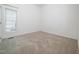 Well lit bedroom with neutral walls and carpet, with a window providing natural light at 11221 Paddy Hollow Ln, Raleigh, NC 27614