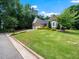 Beautiful brick home featuring lush landscaping and a spacious, green front lawn at 11221 Paddy Hollow Ln, Raleigh, NC 27614