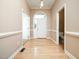 Home foyer with hardwood floors, white trim, and a view of the front door at 11221 Paddy Hollow Ln, Raleigh, NC 27614