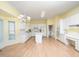 Large kitchen featuring hardwood flooring, white cabinetry, and eat-in dining area at 11221 Paddy Hollow Ln, Raleigh, NC 27614