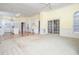 Open-concept living space featuring carpet and view into white kitchen at 11221 Paddy Hollow Ln, Raleigh, NC 27614