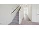 Clean and modern staircase with carpeted steps and a sleek black railing at 1168 Solace Way, Rolesville, NC 27571