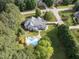Aerial view of a stunning home with a sparkling pool, lush landscaping, and a private backyard oasis at 1201 Kalworth Rd, Wake Forest, NC 27587