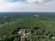 Expansive aerial view of a neighborhood surrounded by lush greenery and mature trees at 1201 Kalworth Rd, Wake Forest, NC 27587