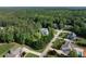 An aerial view showcasing a home nestled in a lush, wooded neighborhood offering both privacy and community at 1201 Kalworth Rd, Wake Forest, NC 27587