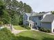 Spacious backyard featuring a patio, lush lawn, mature trees, and a charming screened-in porch at 1201 Kalworth Rd, Wake Forest, NC 27587