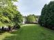 Expansive backyard with lush green grass, mature trees, and space for outdoor enjoyment and entertaining at 1201 Kalworth Rd, Wake Forest, NC 27587