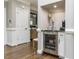 Convenient bar area with wine fridge, tile backsplash, and marble countertops, ideal for entertaining guests at 1201 Kalworth Rd, Wake Forest, NC 27587