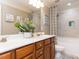 Spacious bathroom with a double sink vanity, white countertops, wood cabinets, a shower, and bath combo at 1201 Kalworth Rd, Wake Forest, NC 27587