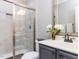 Bathroom featuring a shower, vanity with decorative faucet and sink, stylish gray cabinets, and a toilet at 1201 Kalworth Rd, Wake Forest, NC 27587