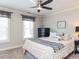 Comfortable bedroom features a ceiling fan, two windows, and neutral colors perfect for a relaxing vibe at 1201 Kalworth Rd, Wake Forest, NC 27587