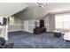 Vaulted bonus room featuring a large window, mounted TV, and unique patterned carpet at 1201 Kalworth Rd, Wake Forest, NC 27587
