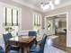 Bright dining room with pendant lighting, stylish blue chairs, and a window view at 1201 Kalworth Rd, Wake Forest, NC 27587
